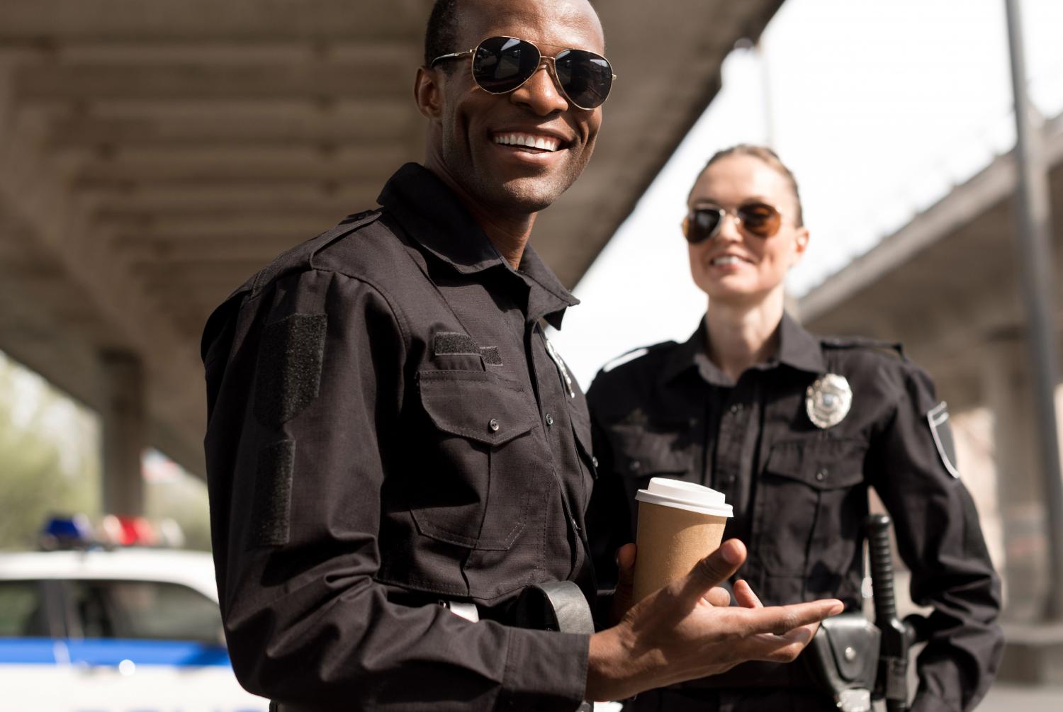 happy-young-police-officers-having-coffee-break-2021-08-29-21-23-09-utc-edited